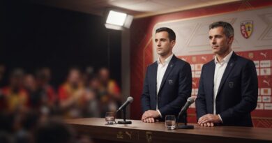 A professional sports journalism photograph of Benjamin Parrot and Jean-Louis Leca standing together behind a press conference table in a modern media room, appearing serious and focused.